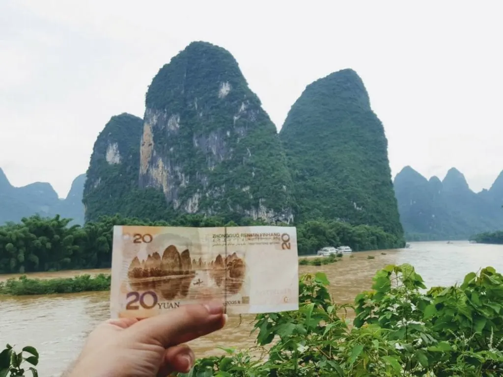 A photo of a 20 Yuan note in front of 20 Yuan note mountain, Yanshuo, guilin mountains, yangshuo mountains, 
