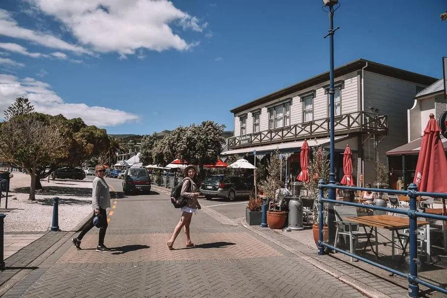 Akaroa-Wharf, Girls crossing at Akaroa Wharf, Akaroa, Akaroa-New-Zealand, Akaroa-Christchurch, Christchurch-day-trip, south-island-road-trip-itinerary, 2-week-new-zealand-itinerary, 7-day-south-island-itinerary