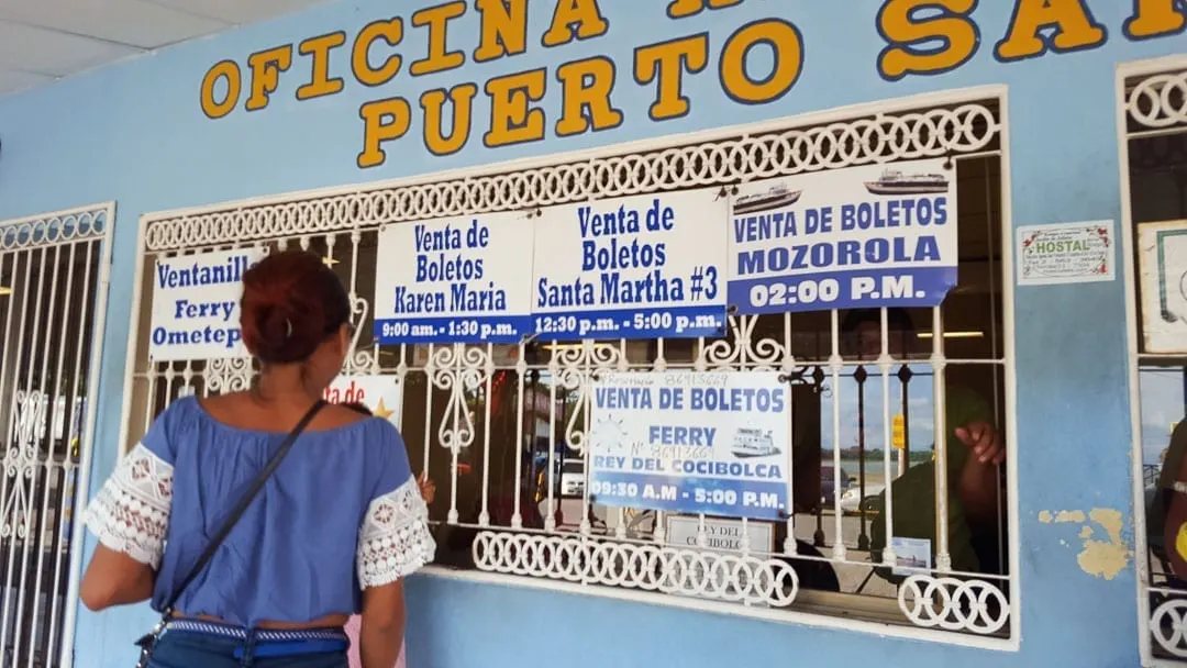 Woman-buying-Isla-de-Ometepe-ferry-tickets