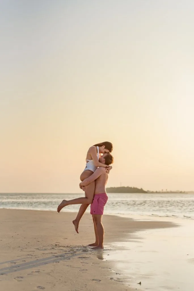 Romantic couple posing at stone beach Stock Photo by ©AnnHaritonenko  75375857