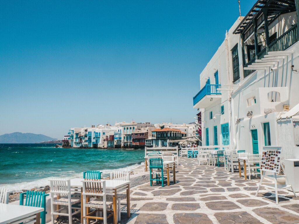Tables and chairs for romantic oceanside dining in Mykonos