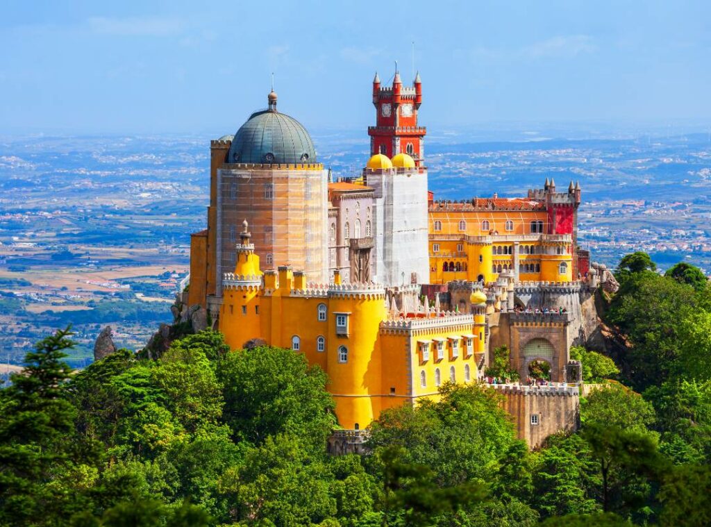 The colourful yellow and red castle of Sintra viewed from a drone