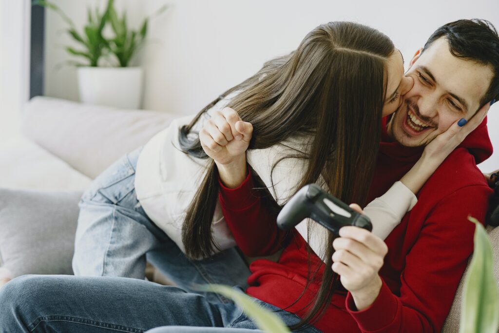 How do I know he loves me? Couple laughing playing video games